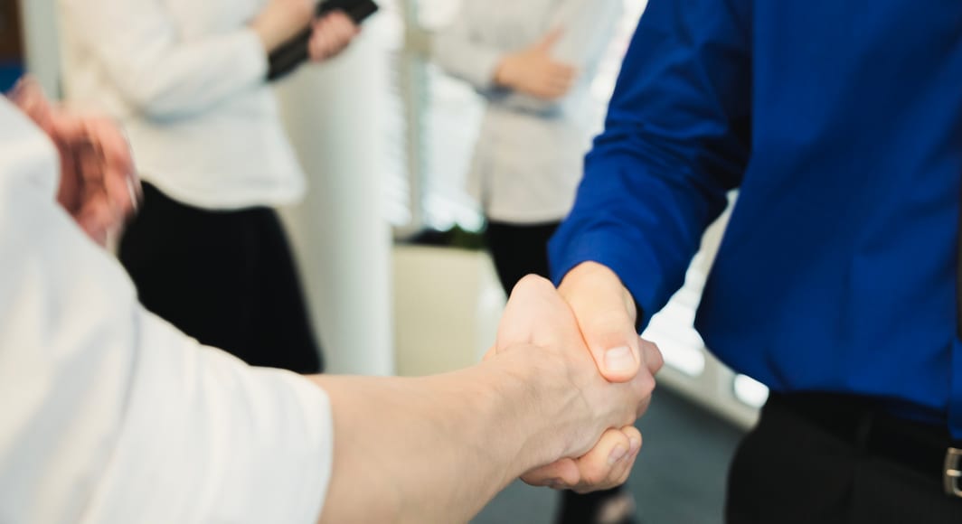 Crop shot men shaking hands